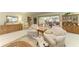 A spacious living room with wall-to-wall carpet has light-green walls and lots of wood furniture at 4611 17Th W Ave, Bradenton, FL 34209
