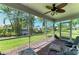 Cozy screened porch with fan and brick flooring offers a seamless transition to a private backyard at 4611 17Th W Ave, Bradenton, FL 34209