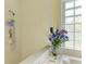 Close-up of a shower with flowers by the window, complete with marble tiling at 4611 17Th W Ave, Bradenton, FL 34209