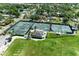 Aerial view of neighborhood tennis courts with green landscaping and mature trees at 4611 17Th W Ave, Bradenton, FL 34209