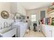 This utility room features a stainless steel sink, white cabinets and a Whirlpool washing machine at 4611 17Th W Ave, Bradenton, FL 34209