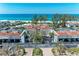 Stunning aerial view of beachside condos with access to tennis courts and a pristine sandy beach at 5055 Gulf Of Mexico Dr # 232, Longboat Key, FL 34228