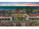 Beautiful aerial shot of a beachfront condo community with lush landscaping, tennis courts, and private parking at 5055 Gulf Of Mexico Dr # 232, Longboat Key, FL 34228