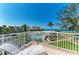 Beautiful balcony view overlooking the pool, grounds, and ocean at 5055 Gulf Of Mexico Dr # 232, Longboat Key, FL 34228