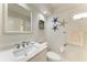 Elegant bathroom features a modern vanity, decorative mirror, and coastal-themed accents at 5055 Gulf Of Mexico Dr # 232, Longboat Key, FL 34228