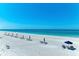 Beautiful beach with rows of chairs and umbrellas offering a serene escape by the water at 5055 Gulf Of Mexico Dr # 232, Longboat Key, FL 34228