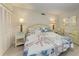 Comfortable bedroom with floral bedding, closet, and seating area at 5055 Gulf Of Mexico Dr # 232, Longboat Key, FL 34228