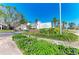 Inviting entrance to Club Longboat Key, surrounded by lush landscaping and mature trees at 5055 Gulf Of Mexico Dr # 232, Longboat Key, FL 34228