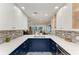 This kitchen features a sink with ocean views, white countertops, blue cabinets, and backsplash at 5055 Gulf Of Mexico Dr # 232, Longboat Key, FL 34228