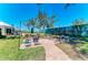 Outdoor patio area with tables and chairs under the bright blue sky at 5055 Gulf Of Mexico Dr # 232, Longboat Key, FL 34228
