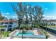 Inviting community pool area with lounge chairs and beautiful landscaping, perfect for relaxation at 5055 Gulf Of Mexico Dr # 232, Longboat Key, FL 34228