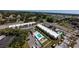 Aerial view of the condo complex showcases a refreshing pool and well-manicured landscaping at 519 Albee Farm Rd # 201, Venice, FL 34285
