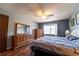 A large bedroom has a ceiling fan and laminate floors, two dressers, and a sunny window at 519 Albee Farm Rd # 201, Venice, FL 34285