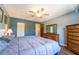 This bedroom has neutral paint, ceiling fan, laminate floors, closet, and a wooden dresser with mirror at 519 Albee Farm Rd # 201, Venice, FL 34285