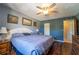 Cozy bedroom featuring beautiful laminate floors, a ceiling fan, and a closet for ample storage at 519 Albee Farm Rd # 201, Venice, FL 34285