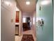 Inviting hallway leads to a cozy living area with warm, hardwood floors and ample natural light at 519 Albee Farm Rd # 201, Venice, FL 34285