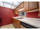 Kitchen featuring wood cabinets, stainless steel sink, and black dishwasher at 519 Albee Farm Rd # 201, Venice, FL 34285
