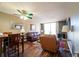 Comfortable living room with wood floors and ceiling fan, open to dining area at 519 Albee Farm Rd # 201, Venice, FL 34285