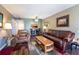 Comfortable living room with updated laminate floors, leather furniture and a view of the kitchen bar at 519 Albee Farm Rd # 201, Venice, FL 34285