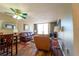 Cozy living room with wood floors, comfortable leather seating, and a ceiling fan at 519 Albee Farm Rd # 201, Venice, FL 34285