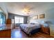 Comfortable main bedroom with laminate flooring, a ceiling fan, and natural light at 519 Albee Farm Rd # 201, Venice, FL 34285