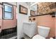 Bathroom features pink tile walls and a modern white vanity with an updated shower at 528 45Th St, Sarasota, FL 34234