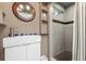 Updated bathroom with a modern white sink with decorative tiles, a unique mirror, and a tiled walk-in shower at 528 45Th St, Sarasota, FL 34234