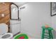 Modern bathroom with sleek sink, wooden mirror, and contrasting green accents at 528 45Th St, Sarasota, FL 34234