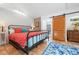 A bright bedroom with an iron bed, wooden floors, and a cozy atmosphere at 528 45Th St, Sarasota, FL 34234