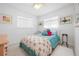 Bright bedroom featuring two windows, a throw blanket, and neutral color scheme at 528 45Th St, Sarasota, FL 34234