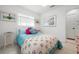 Cozy bedroom featuring bright decor, including a colorful throw blanket and decorative stained glass at 528 45Th St, Sarasota, FL 34234