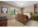 Cozy bedroom with a wicker bed frame, a shag area rug, and natural light at 528 45Th St, Sarasota, FL 34234