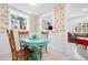 Charming breakfast nook featuring a quaint blue table, vintage wallpaper, and sunlit windows at 528 45Th St, Sarasota, FL 34234