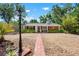 Charming single-story home with a well-manicured front yard, featuring a brick walkway and lush landscaping at 528 45Th St, Sarasota, FL 34234