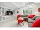 Inviting living room with a built-in entertainment center, natural light, and cozy seating at 528 45Th St, Sarasota, FL 34234