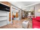 Open-concept living room featuring a TV, shelving, and seamless access to the kitchen at 528 45Th St, Sarasota, FL 34234