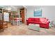 Open-concept living room featuring a red sofa and seamless access to the kitchen at 528 45Th St, Sarasota, FL 34234
