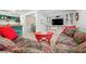 Open concept living room with a floral sofa, colorful table, and views of the kitchen at 528 45Th St, Sarasota, FL 34234