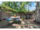 Cozy backyard patio with a table and chairs, surrounded by trees and greenery at 528 45Th St, Sarasota, FL 34234