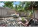 Charming backyard patio with wooden deck, brick accents, and lush green foliage at 528 45Th St, Sarasota, FL 34234