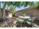 Backyard patio area with a wooden deck and table, surrounded by lush greenery at 528 45Th St, Sarasota, FL 34234