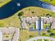 Overhead view featuring community layout with residences, carports, pond, and surrounding green areas at 6209 Heritage Ln # 6209, Bradenton, FL 34209