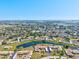 Scenic aerial view of community with pond, residences, and lush landscaping extending to the horizon at 6209 Heritage Ln # 6209, Bradenton, FL 34209