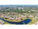 An aerial view shows homes and a peaceful pond in this desirable community with mature trees at 6209 Heritage Ln # 6209, Bradenton, FL 34209