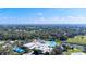 A community recreation center with multiple swimming pools, tennis courts, and lush landscape from above at 6209 Heritage Ln # 6209, Bradenton, FL 34209