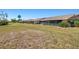Lush backyard featuring a well-maintained lawn, shrubs, and a view of the neighborhood at 6209 Heritage Ln # 6209, Bradenton, FL 34209