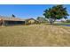 Backyard with an expansive lawn and views of mature trees and a nearby lake at 6209 Heritage Ln # 6209, Bradenton, FL 34209