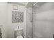 Bathroom featuring white tile shower and decorative wall art above a toilet at 6209 Heritage Ln # 6209, Bradenton, FL 34209