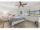 Bright bedroom with a ceiling fan, a large window, and a white-framed bed at 6209 Heritage Ln # 6209, Bradenton, FL 34209