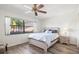Bedroom showcasing a neatly made bed, wooden floors, and a sunlit window view at 6209 Heritage Ln # 6209, Bradenton, FL 34209